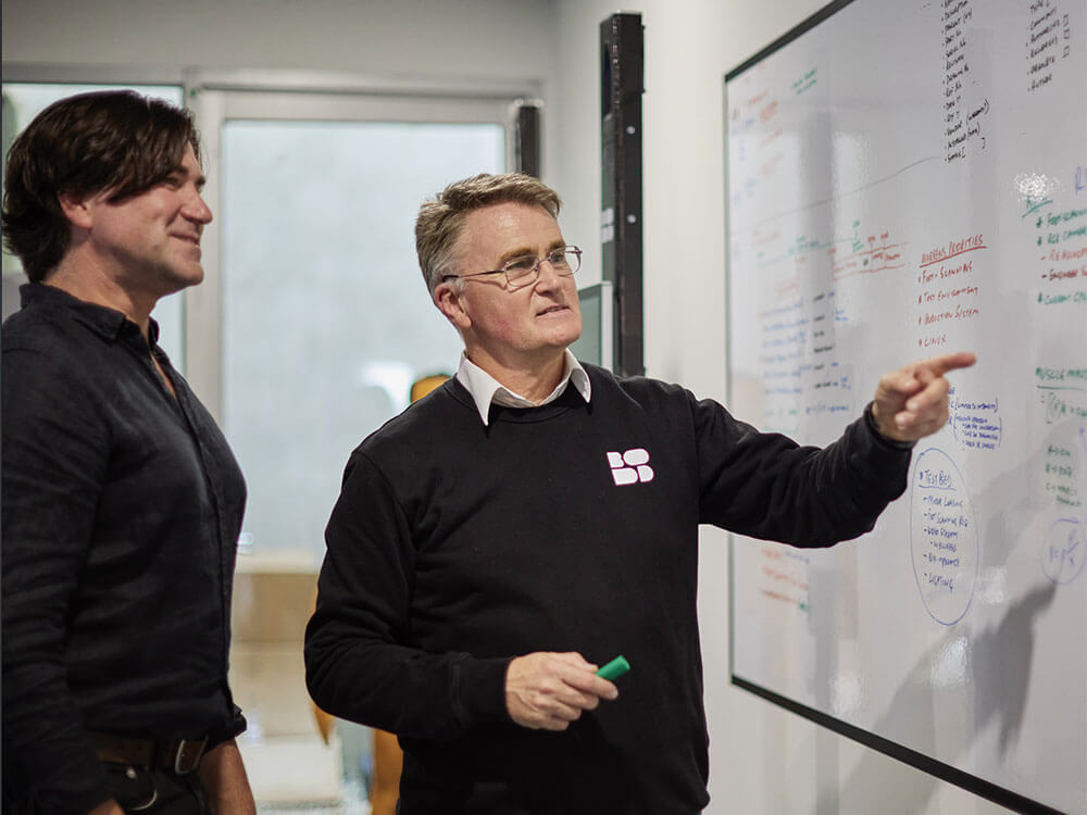 Bodd staff working in front of white board