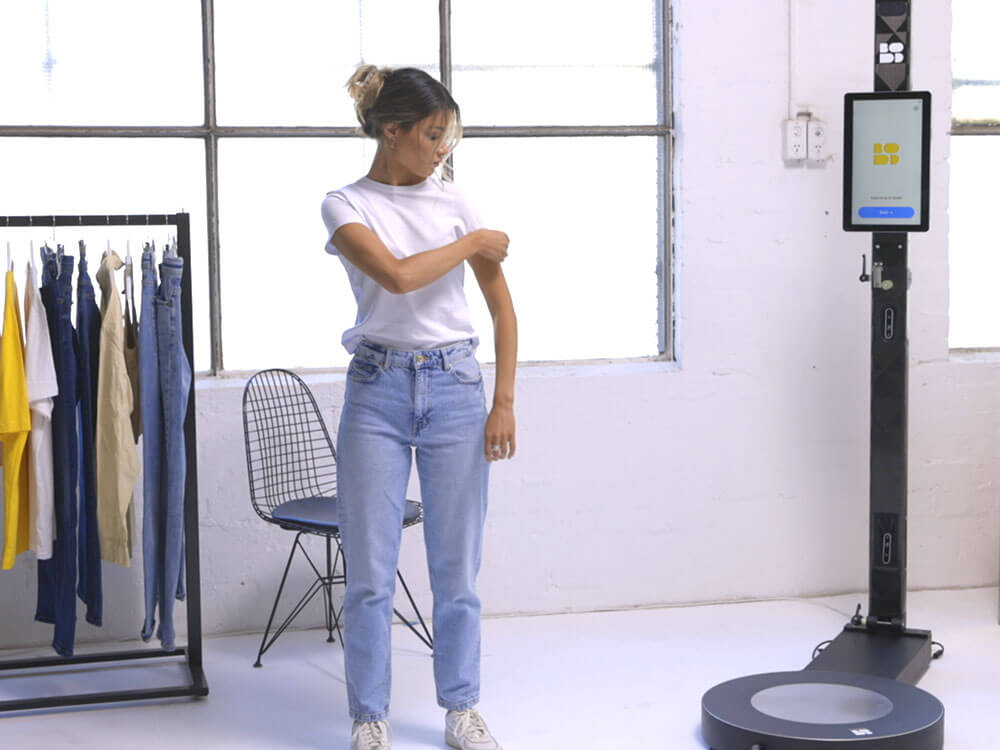 Woman fitting clothes after being scanned
